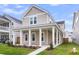 Charming two-story home featuring a welcoming front porch with stately white columns and a well-manicured lawn at 1017 Marsh Royal St, Summerville, SC 29485