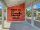 Outdoor farmers market area with a welcoming painted sign and shaded picnic tables at 1017 Marsh Royal St, Summerville, SC 29485