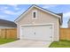 Close-up view of the garage featuring a white garage door and beige siding at 1017 Marsh Royal St, Summerville, SC 29485