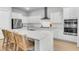Stylish kitchen with white cabinets, stainless steel appliances, and large center island with modern countertops and seating at 1017 Marsh Royal St, Summerville, SC 29485
