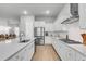 Modern kitchen featuring stainless steel appliances, white cabinetry, hardwood flooring, and large island with sink at 1017 Marsh Royal St, Summerville, SC 29485