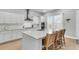 Bright kitchen features white cabinets, stainless steel appliances, large island with bar seating, and lots of natural light at 1017 Marsh Royal St, Summerville, SC 29485