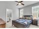 Spacious main bedroom featuring a connecting bathroom, ceiling fan, carpet, and windows at 1017 Marsh Royal St, Summerville, SC 29485