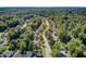 An aerial view of the property nestled in a neighborhood with tree-lined streets and nicely kept lawns and landscaping at 105 Moon Shadow Ln, Summerville, SC 29485
