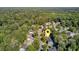 The aerial view captures a residential area with tree-lined streets and houses situated among a forest backdrop at 105 Moon Shadow Ln, Summerville, SC 29485