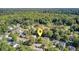 An aerial view of the property nestled in a lush, green neighborhood with mature trees and well-maintained homes at 105 Moon Shadow Ln, Summerville, SC 29485