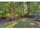 The backyard features a privacy fence with mature trees and plantings at 105 Moon Shadow Ln, Summerville, SC 29485