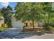 Charming two-story home with a well-manicured lawn, complemented by mature trees and a two car garage at 105 Moon Shadow Ln, Summerville, SC 29485