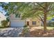 Charming two-story home with a well-manicured lawn, complemented by mature trees and a two car garage at 105 Moon Shadow Ln, Summerville, SC 29485