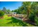 Lush backyard featuring a garden area with raised beds, a pergola, and a well-manicured lawn at 105 Northpark Ave, Summerville, SC 29485