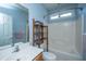 Well-lit bathroom with a tub, shower, white tile and a vanity with ample storage space at 105 Northpark Ave, Summerville, SC 29485