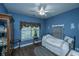 Comfortable bedroom featuring blue walls, a ceiling fan, wood floors and a window with natural light at 105 Northpark Ave, Summerville, SC 29485