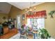 Charming dining room area with tile flooring, a unique chandelier, and a view to the outside at 105 Northpark Ave, Summerville, SC 29485