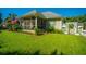 Charming home exterior with screened porch, manicured lawn, white picket fence, and American flag at 105 Northpark Ave, Summerville, SC 29485