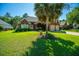 Beautiful brick home featuring a lush green lawn, mature palm tree, and convenient two-car garage at 105 Northpark Ave, Summerville, SC 29485