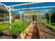 Charming garden with raised beds and a white pergola, perfect for growing vegetables and flowers at 105 Northpark Ave, Summerville, SC 29485
