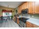 Cozy kitchen with tile floor, stainless steel appliances, and wooden cabinets at 105 Northpark Ave, Summerville, SC 29485