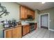 Galley style kitchen with wood cabinets, stainless steel appliances, and tiled floors at 105 Northpark Ave, Summerville, SC 29485