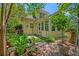 A view of the home's exterior and landscaped backyard with an arbor and sun room at 106 Sago Palm Ct, Summerville, SC 29483
