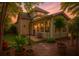 Landscaped backyard featuring an arbor, patio with bench, and manicured greenery at 106 Sago Palm Ct, Summerville, SC 29483