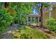 A view of the yard, landscaping, and screened porch of this beautiful home at 106 Sago Palm Ct, Summerville, SC 29483