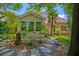 Backyard featuring a stone path, trees, plants, and the rear exterior of the home at 106 Sago Palm Ct, Summerville, SC 29483