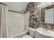 Bathroom with floral wallpaper, shower and tub combination, and a mirror at 106 Sago Palm Ct, Summerville, SC 29483