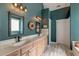 Bathroom with double vanity, rustic light fixtures, wood look tile floor and teal colored walls at 106 Sago Palm Ct, Summerville, SC 29483