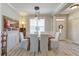 Inviting dining room featuring white chairs, wood floors, crown molding, and elegant lighting at 106 Sago Palm Ct, Summerville, SC 29483