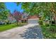 Charming two-story brick home with a well-manicured lawn and a long driveway leading to a two-car garage at 106 Sago Palm Ct, Summerville, SC 29483