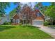 Attractive brick house with a manicured front lawn, flowering tree, and attached two-car garage at 106 Sago Palm Ct, Summerville, SC 29483