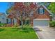 Attractive brick home with a well-maintained lawn and a beautiful tree in the front yard at 106 Sago Palm Ct, Summerville, SC 29483