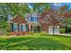 Charming two-story brick home with well-manicured lawn, teal shutters, and inviting curb appeal at 106 Sago Palm Ct, Summerville, SC 29483