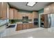 Well-equipped kitchen featuring light wood cabinetry, stainless steel appliances, and ample counter space at 106 Sago Palm Ct, Summerville, SC 29483