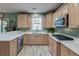 Modern kitchen with stainless steel appliances, light wood cabinets, and white countertops at 106 Sago Palm Ct, Summerville, SC 29483