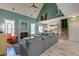 Comfortable living room boasts high ceilings, a fireplace, a large sectional, and an open floor plan at 106 Sago Palm Ct, Summerville, SC 29483