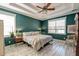 Comfortable main bedroom featuring white plank floors, a ceiling fan, and natural lighting at 106 Sago Palm Ct, Summerville, SC 29483