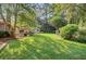 Lush backyard featuring a patio with seating, mature trees, and a well-manicured lawn at 108 E Walker Dr, Summerville, SC 29483