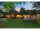 Expansive backyard featuring lush lawn, mature trees, and outdoor seating areas at 108 E Walker Dr, Summerville, SC 29483