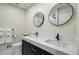 Modern bathroom with dual sinks, black hardware, and contemporary lighting and fixtures at 108 E Walker Dr, Summerville, SC 29483