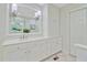 Bathroom features white cabinets, a large mirror, and great lighting at 108 E Walker Dr, Summerville, SC 29483