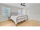 Bedroom with a black metal bed frame, white walls, hardwood floors, and bright natural lighting at 108 E Walker Dr, Summerville, SC 29483
