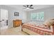Well-lit bedroom featuring hardwood floors, ceiling fan, and ensuite bathroom at 108 E Walker Dr, Summerville, SC 29483