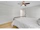 Bright bedroom with light wood floors, ceiling fan, and white wainscotting at 108 E Walker Dr, Summerville, SC 29483