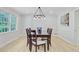 Elegant dining room with modern lighting, stylish table setting, and ample natural light at 108 E Walker Dr, Summerville, SC 29483