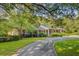 Charming brick home with a covered porch, manicured landscaping, and a welcoming circular driveway at 108 E Walker Dr, Summerville, SC 29483