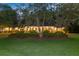 Charming brick home with manicured landscaping illuminated at dusk, showcasing its inviting curb appeal at 108 E Walker Dr, Summerville, SC 29483