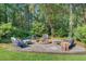 Cozy fire pit area surrounded by comfortable seating in a wooded backyard at 108 E Walker Dr, Summerville, SC 29483
