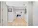 Bright hallway with white walls and light wood floors, offering a view into the adjacent living spaces at 108 E Walker Dr, Summerville, SC 29483