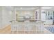 Kitchen island featuring white cabinets, dark countertops, and white chairs at 108 E Walker Dr, Summerville, SC 29483